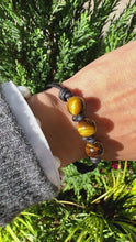 Load and play video in Gallery viewer, Women’s Natural Tiger’s eye on genuine hand rolled leather Mala bracelet

